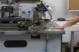 engineer in front of wood cutting machine photo