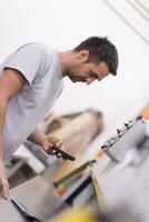 engineer in front of wood cutting machine photo