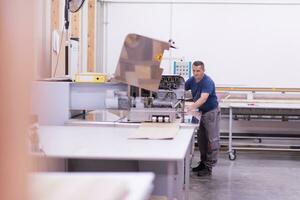 worker in a factory of wooden furniture photo