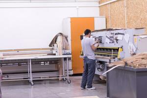 worker in a factory of wooden furniture photo