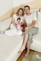 indoor portrait with happy young family and  cute little babby photo