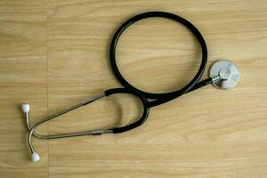 One medical stethoscope on wooden background photo