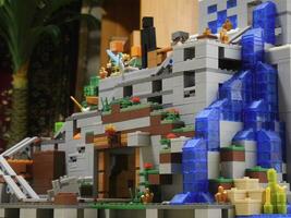 big lego constructor in the style of minecraft, adventure on mountain with waterfall photo