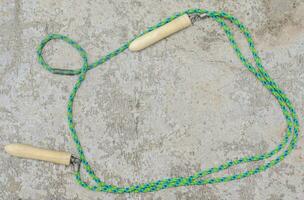 Jump rope on cement floor background with copy space, Top view, health care concept. photo