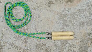 Jumping rope on cement floor background with copy space, Top view, health care concept. photo