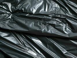 crumpled black plastic texture background. photo