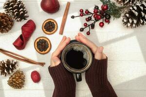 Hands Holding Coffee with Holiday Theme photo
