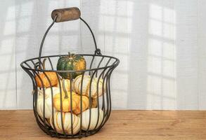 Antique Metal Basket Filled with Colorful Gourd photo