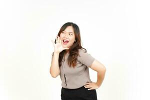 Announcement with hands over mouth Of Beautiful Asian Woman Isolated On White Background photo