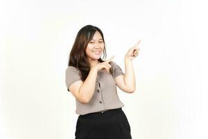 Showing Product and Pointing Blank Side using forefinger Of Beautiful Asian Woman Isolated On White Background photo