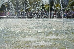 Water splashes from fountain on dark background.Water texture. photo