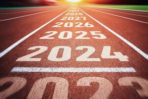Start of new year. Changes of year 2024, 2025, 2026 on Running track. Concept of new ideas starting in new year, planning along with setting objectives to set KPI goals for success in life. photo