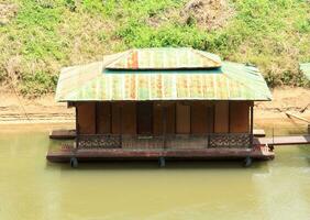 floating houseboat on the Kwai Noi River is a peaceful retreat for nature lovers, homestay accommodation and a famous place in Thailand in Kanchanaburi. photo