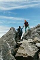 Climbers high-five each other at the top of the mountain. photo