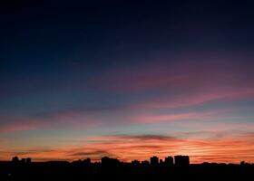 Beautiful sunset sky over city photo