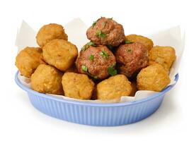 fried balls with meatballs and salad in a plate isolated on white background. photo