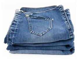 stack of jeans on white background photo