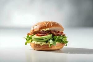 Fresh bagel bun with bacon, avocado and green salad on white table, light background. Copy space. AI generated. photo