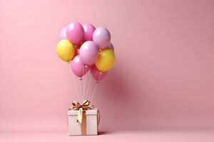 Colorful balloons bunch tied with a gift box on a pink wall background with copy space. Birthday, wedding, party or celebration concept. Generated AI. photo