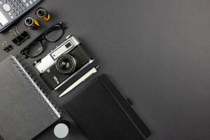 Workplace on black table of a creative designer or photographer with photography equipment. Stylish home studio concept flat lay of technology trends. Top view. Copy space. photo