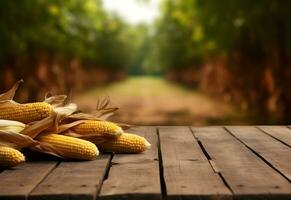 Wooden table with corn on cobs and free space on nature blurred background. Generated AI. photo