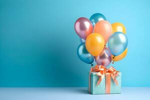 Colorful balloons bunch tied with a gift box on a blue wall background with copy space. Birthday, wedding, party or celebration concept. Generated AI. photo