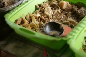 Selective focus sayur lodeh nangka young jackfruit vegetable served in a pan. It is a traditional Indonesian food, this vegetable uses full kitchen spices, coconut milk and usually given Indonesian photo