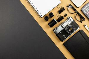 Workplace on black table of a creative designer or photographer with photography equipment. Stylish home studio concept flat lay of technology trends. Top view. Copy space. photo