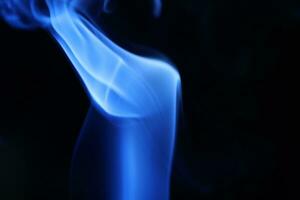 Blue smoke on a dark background photo