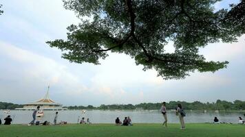 Time Lapse video of the freshwater lake of Suan Luang Rama IX Park where people come to visit and relax on holiday in Bangkok, Thailand.