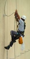 Man climbing a wall photo