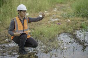 Environmental engineers inspect water quality,Bring water to the lab for testing,Check the mineral content in water and soil,Check for contaminants in water sources. photo