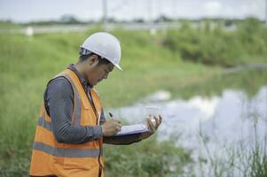 Environmental engineers inspect water quality,Bring water to the lab for testing,Check the mineral content in water and soil,Check for contaminants in water sources. photo