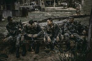 Team of army soldier with machine gun moving in the forest,Thai militia soldier in combat uniforms in the wood,Wander the patrol sloping in the rainforest. photo