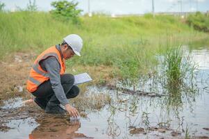 Environmental engineers inspect water quality,Bring water to the lab for testing,Check the mineral content in water and soil,Check for contaminants in water sources. photo