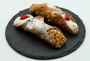 Sweet Sicilian cannoli filled with ricotta cream. Traditional Sicilian Italian dessert photo