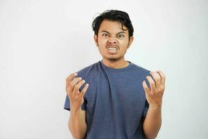 Portrait of angry pensive crazy Asian man screaming. Closeup Young Asian young man panicking isolated on white background. Stress burnout office syndrome overload work hard office male photo