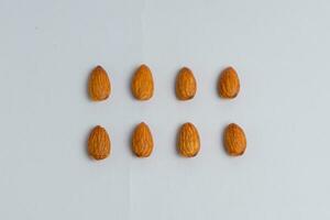 Raw almond clipping path. Almonds isolated on white background. photo