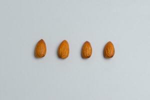 Raw almond clipping path. Almonds isolated on white background. photo