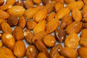 Almonds on white background. Raw peeled almond nuts texture photo