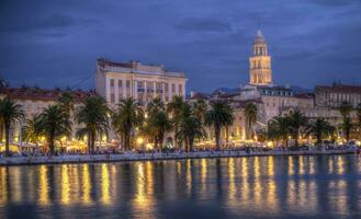 Riva waterfront, houses and Cathedral of Saint Domnius, Dujam, Duje, bell tower Old town by night, Split, Croatia, HDR photo