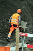 Workers pushing wheelbarrow photo