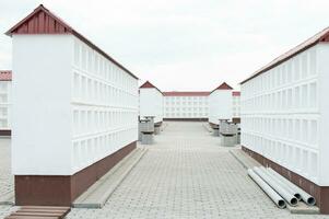 Rows of white walls for the burial of ashes after cremation. Empty cells for urns with ashes. photo