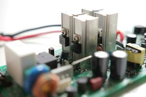 Power Supply modern printed-circuit board with electronic components with transistor. PCB detail photo