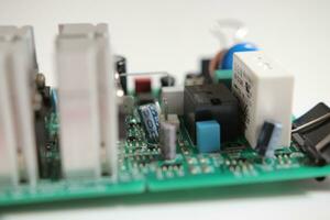 Power Supply modern printed-circuit board with electronic components with transistor. PCB detail photo