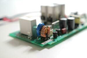 Power Supply modern printed-circuit board with electronic components with transistor. PCB detail photo