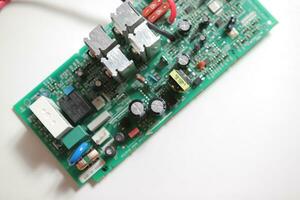 Power Supply modern printed-circuit board with electronic components with transistor. PCB detail photo