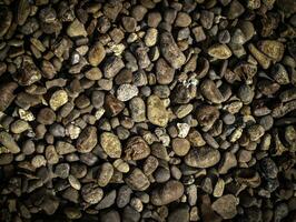 the texture of small light and dark stone pebbles photo