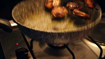 The cook throws the meatballs in the air and spins them in a granite pan video