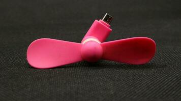 Portable USB pink fan isolated photo